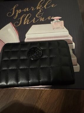 Black Quilted Zip Wallet with Decorative Emblem